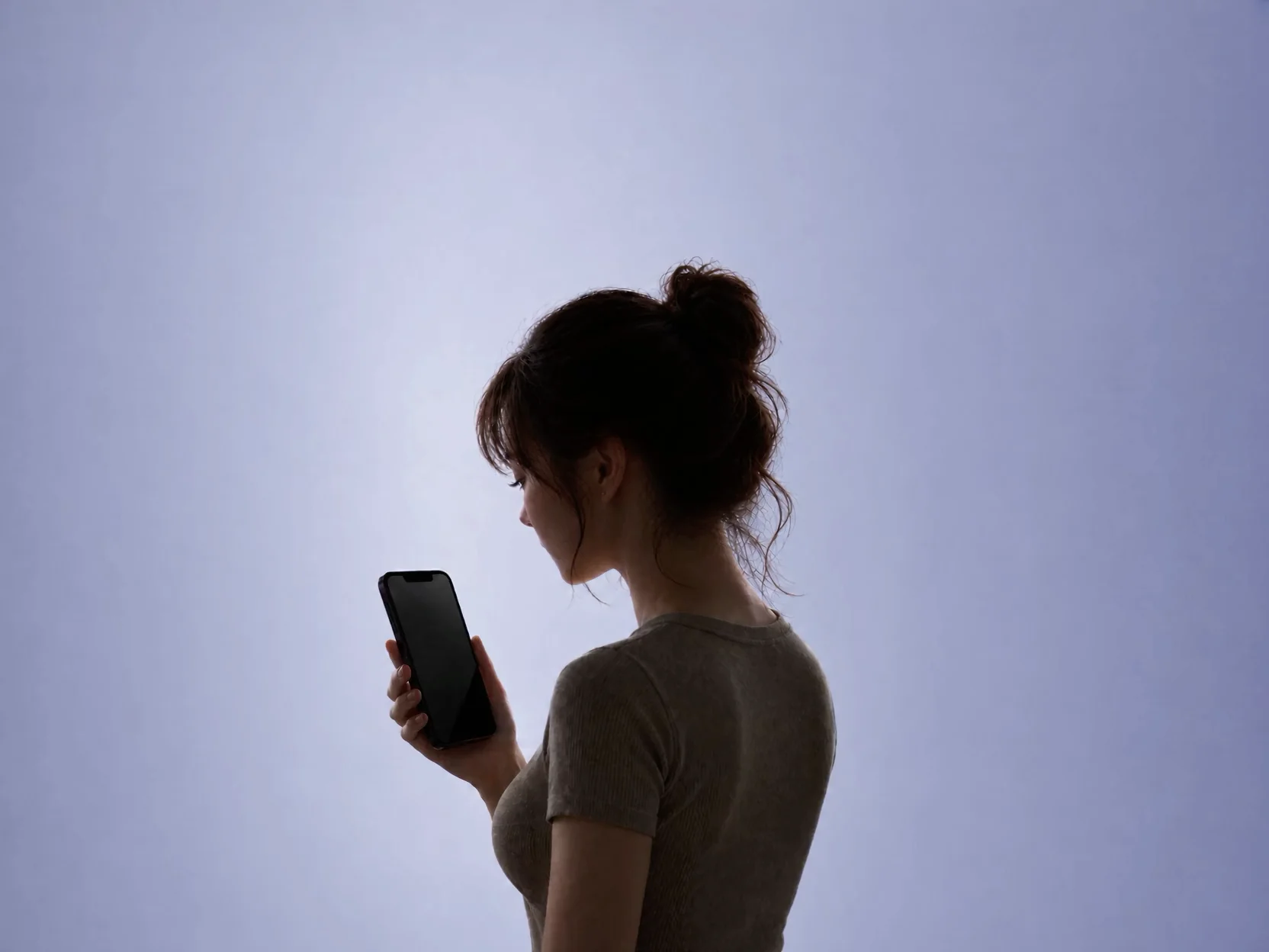 A Korean woman looking down at her phone